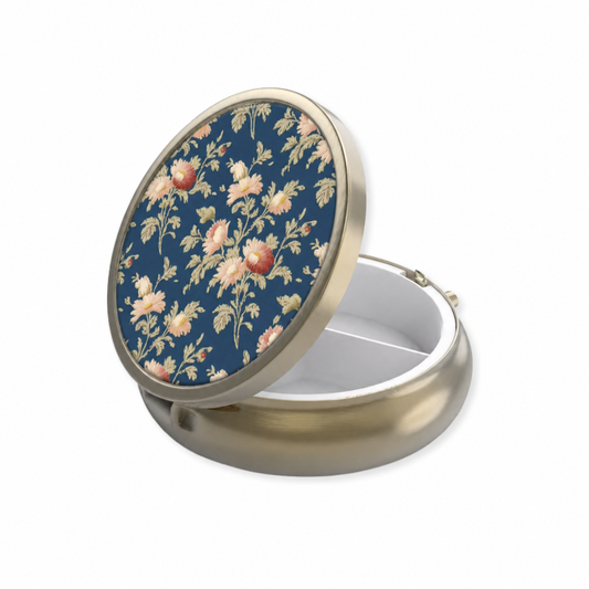 Open round dark blue floral pillbox with floral lid with mirror and divided storage compartments