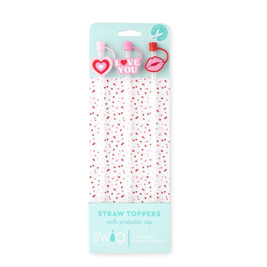 Packaged straw toppers with heart and lips designs on a light blue background