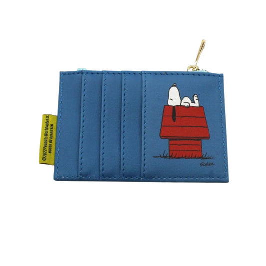 A blue faux-leather coin purse featuring a printed graphic of Snoopy and Woodstock on his red doghouse. The purse has a gold zipper pull and a yellow tag on the left side.