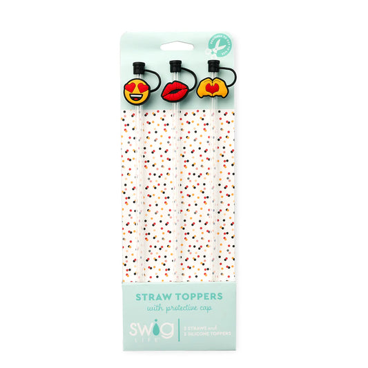 Packaged straw toppers with emoji designs and protective caps on a white background
