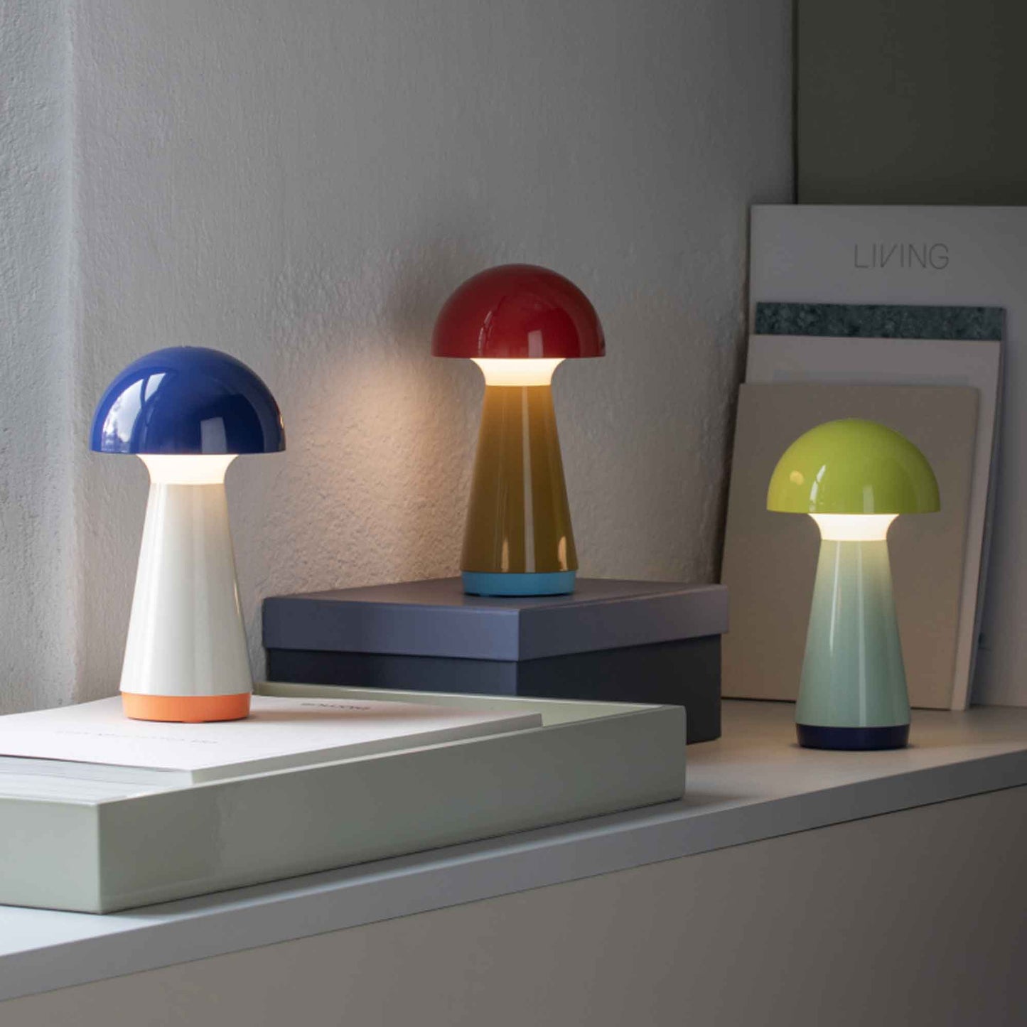 Colorful mushroom-shaped lamps on a shelf with a neutral background