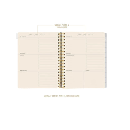 Spiral-bound planner with weekly pages and to-do lists on a white background