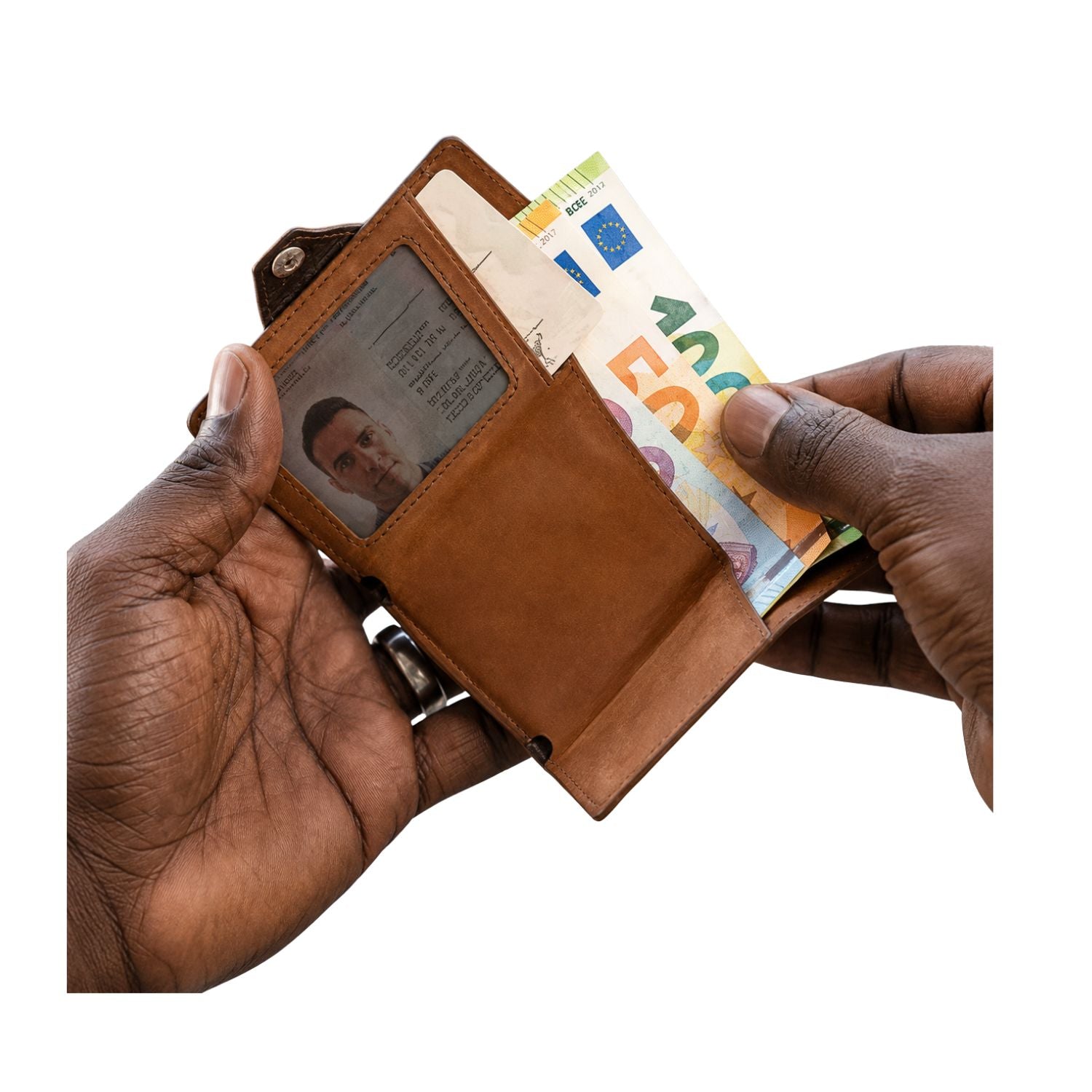 Brown leather wallet with money and cards held by a hand on a white background