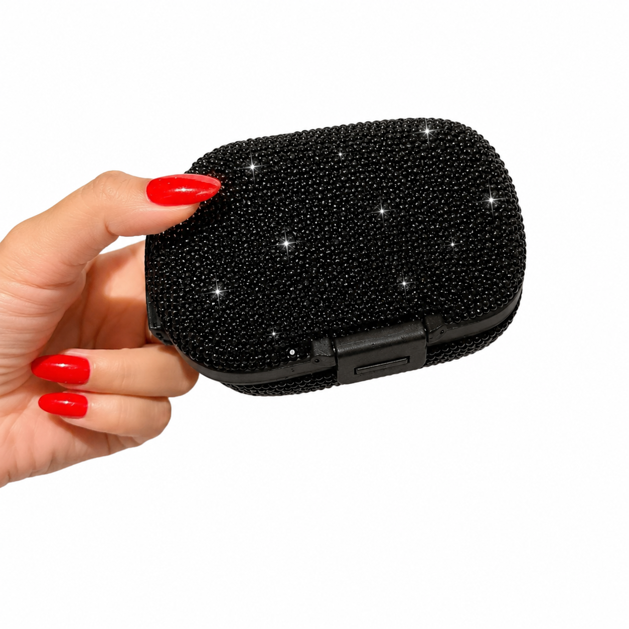 Black bling pillbox held in hand with sparkling rhinestone exterior