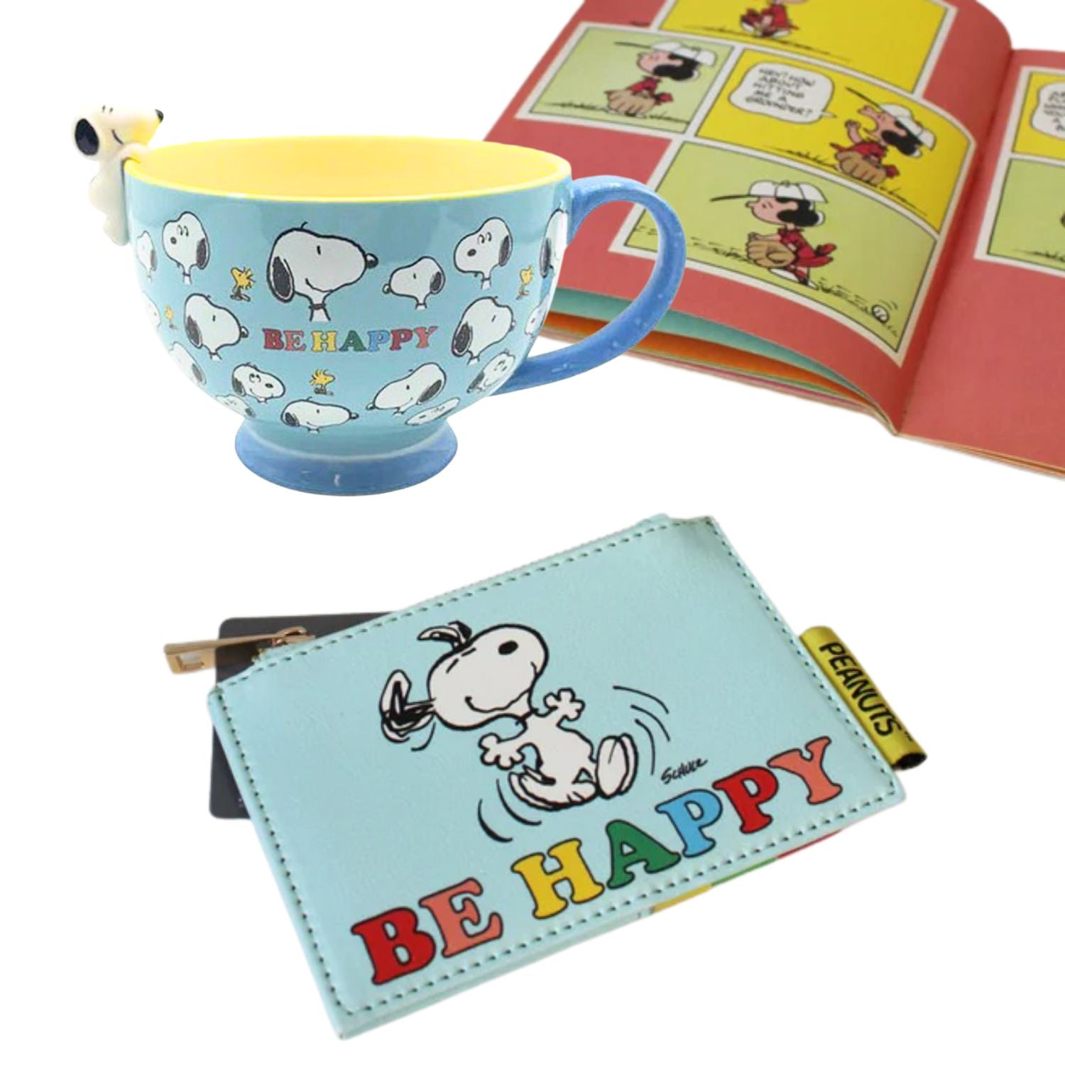 Snoopy-themed mug and wallet with a book in the background