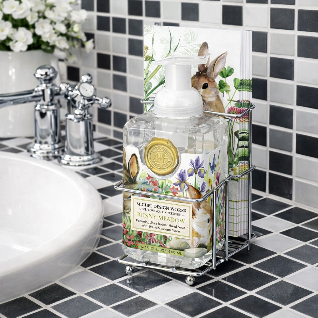 Bathroom sink area with a soap dispenser and decorative holder featuring bunny illustrations.