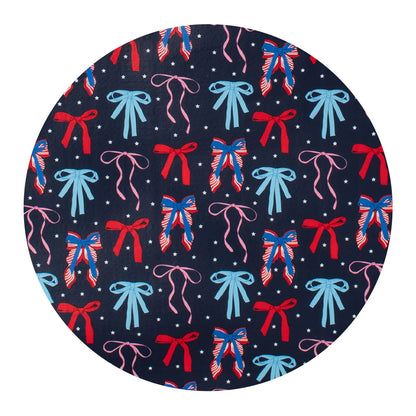 Round swatch with a pattern of colorful bows on a navy background