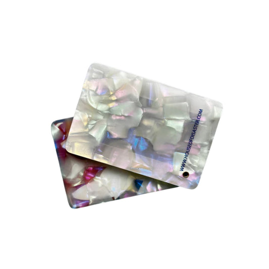 Iridescent backside of tide compact mirror with colorful  sardines  pattern on a white backgrouncd