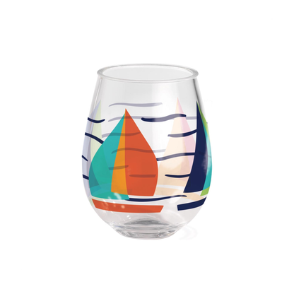 A clear stemless wine glass featuring a colorful graphic print of sailboats on stylized water lines, set against a plain white background.