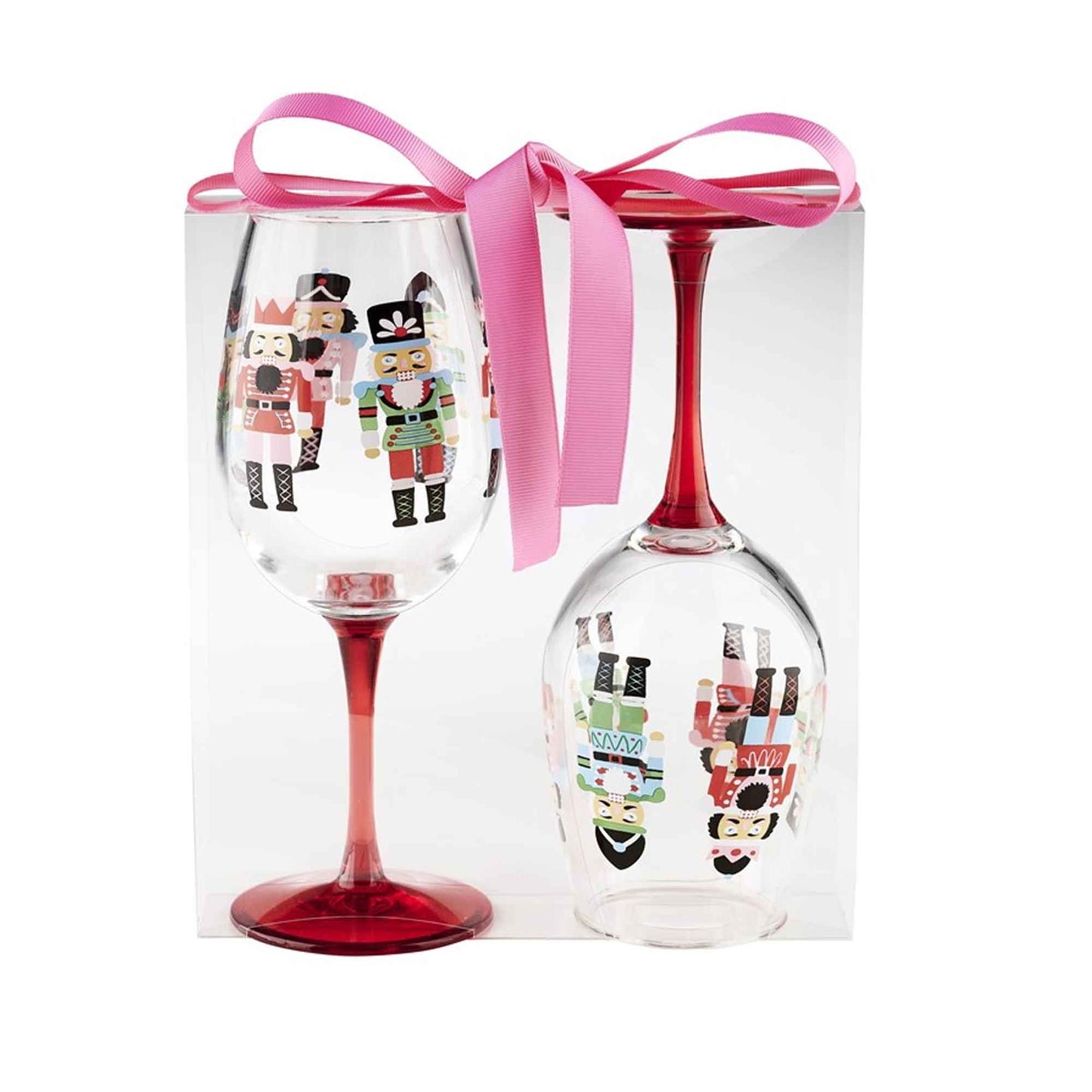 Two acrylic wine glasses with nutcracker designs in a box with a pink ribbon