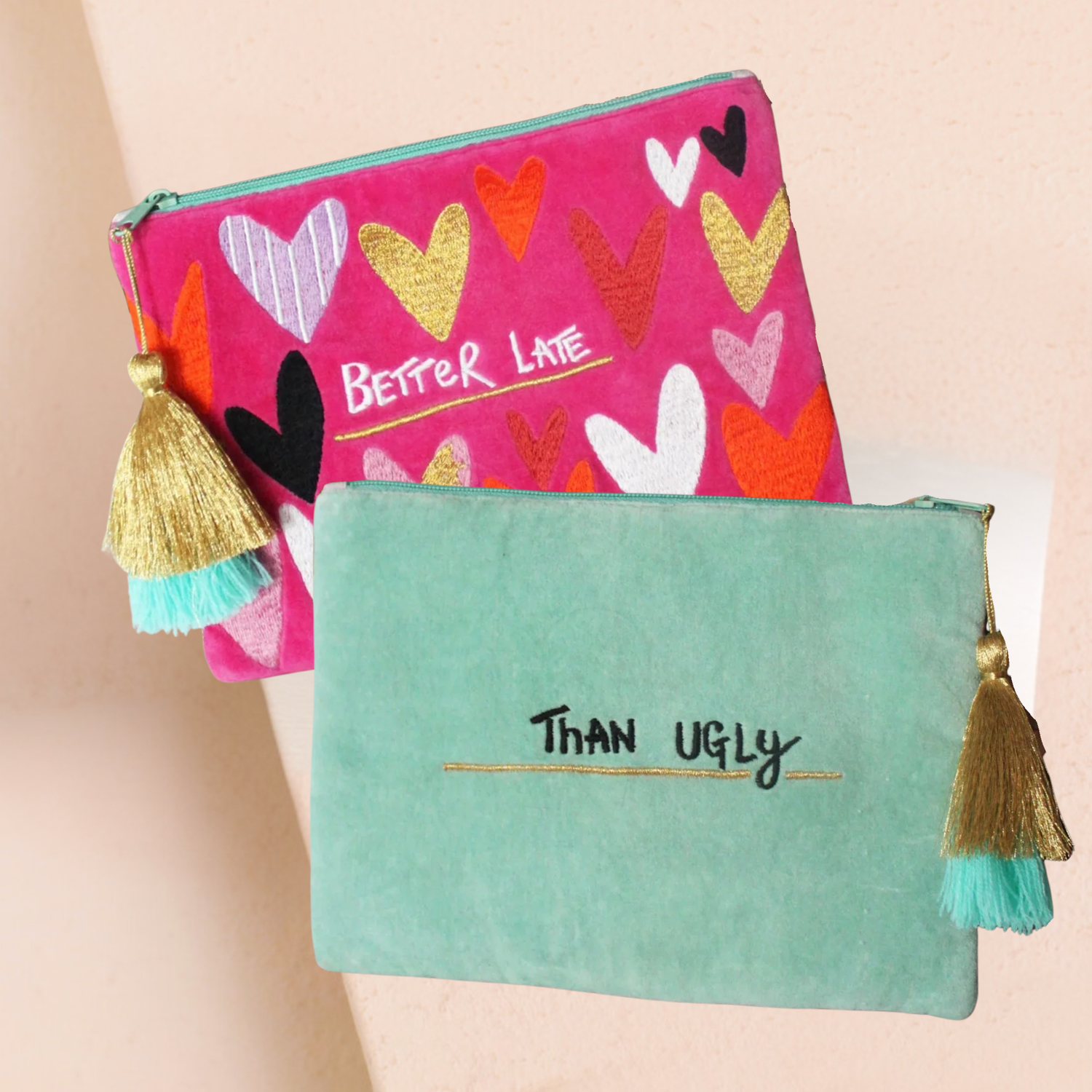 Pouch Front and Back with decorative tassels; one pink with heart patterns and 'Better Late, than ugly" text, the other green with 'Than Ugly' text.