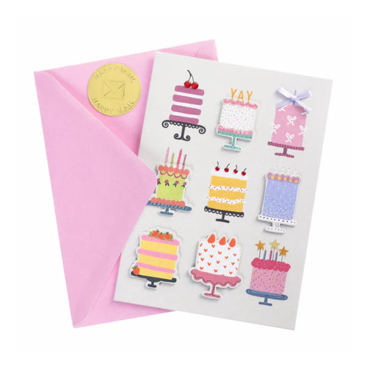 Greeting card with cake illustrations and a pink envelope on a white background