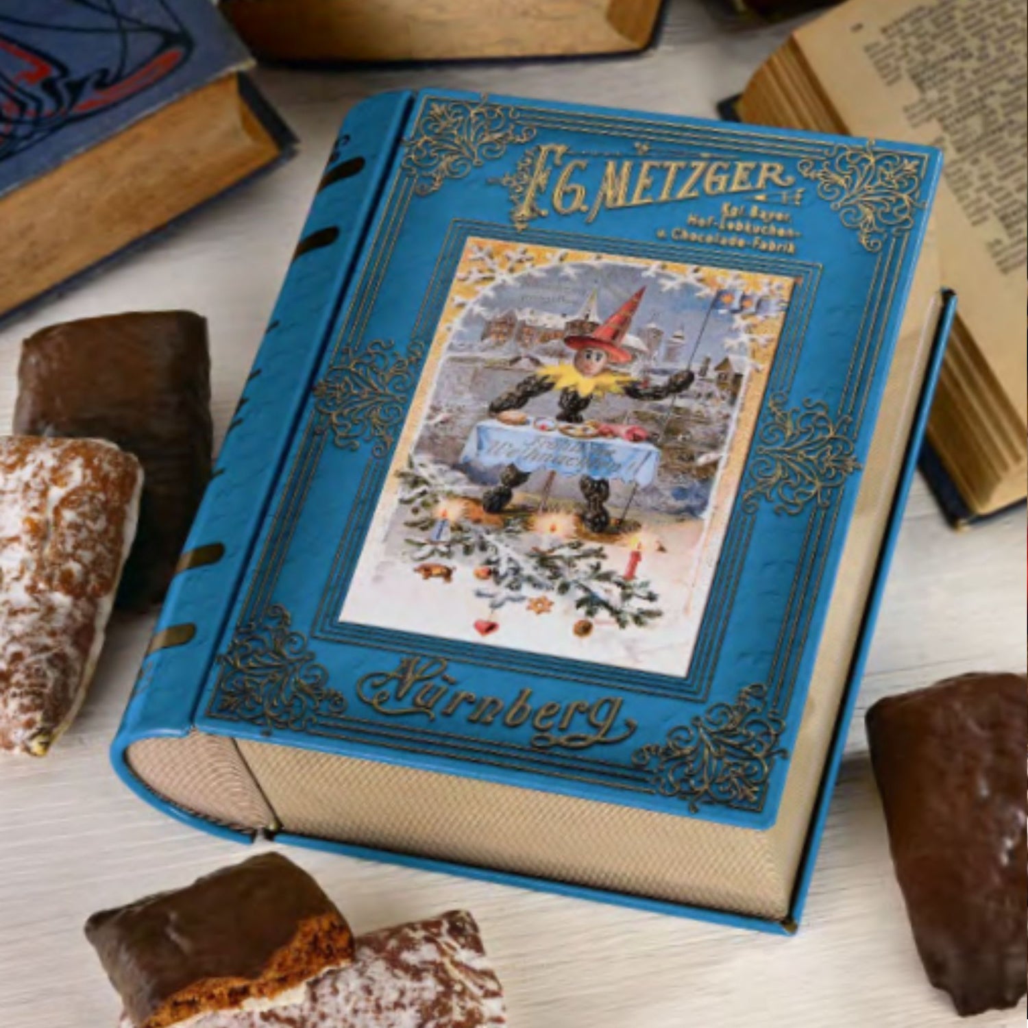 Vintage-style book tin with filled with gingerbread r on a table with pastries