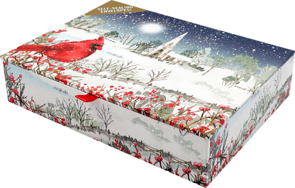 Card box with a cardinal perches on snow- and berry-laden branches, with a country church in the distance. 