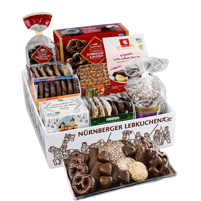 Assorted German cookies and pastries in a decorative box with visible branding.