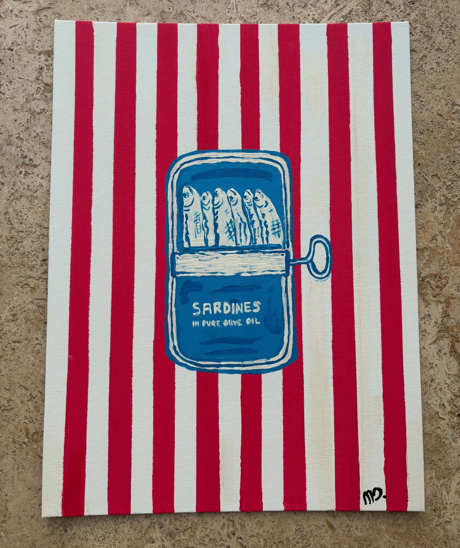 Striped red and white towel with a blue illustration of sardines in a can.