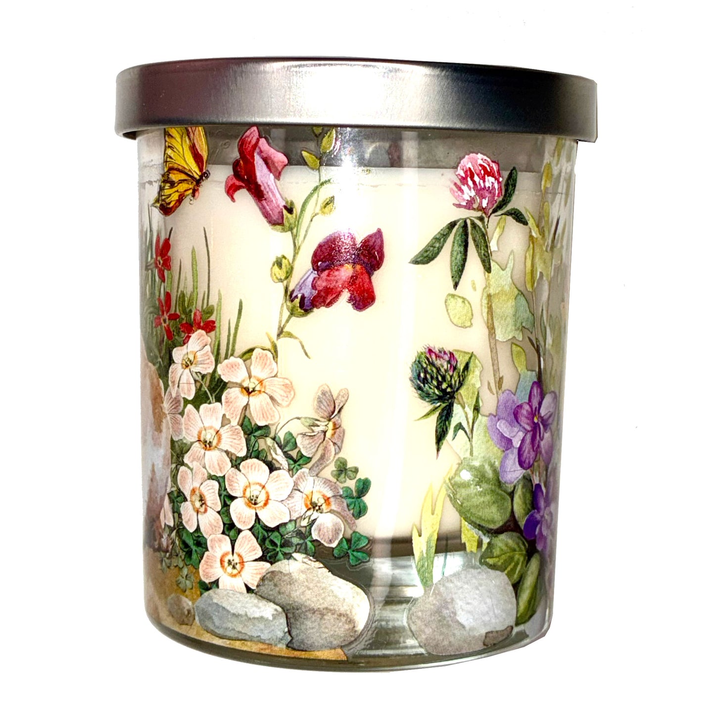 Decorative candle with floral design and metal lid on a white background