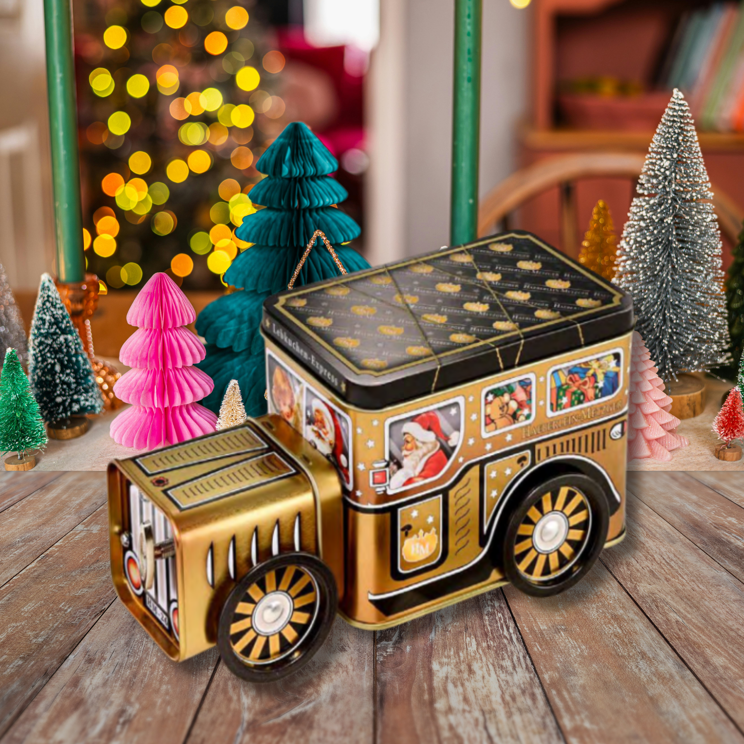 Decorative Christmas tin train on a wooden surface with festive trees in the background.
