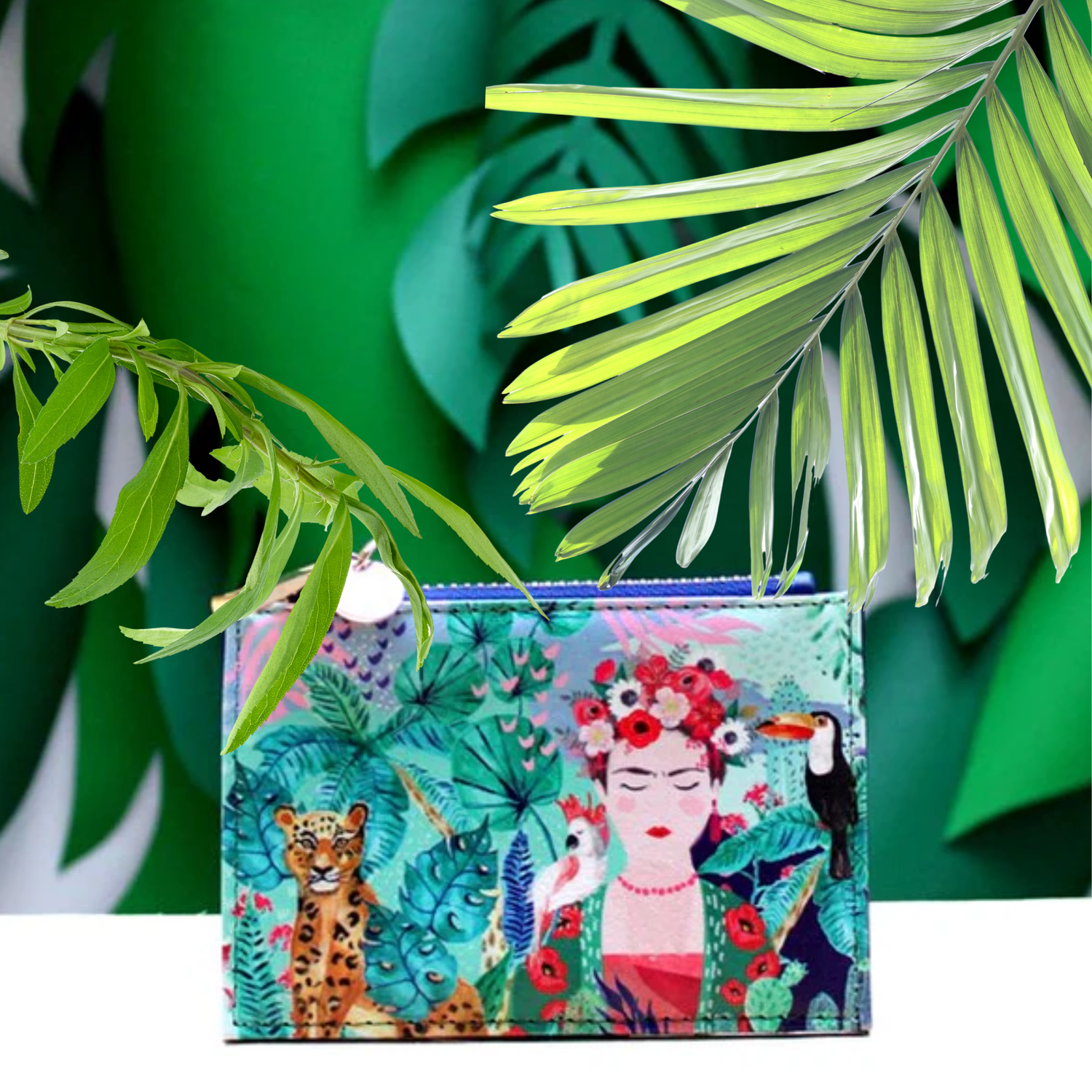 Colorful pouch with artistic design of a woman, animals, and plants on a green leafy background