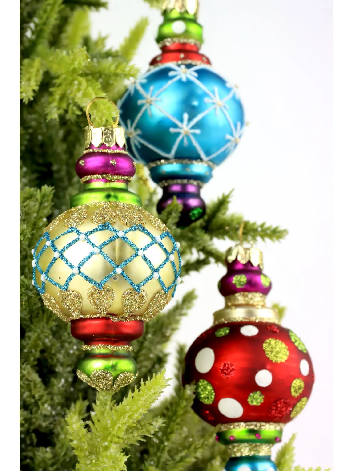 Colorful Christmas tree ornaments on a green tree