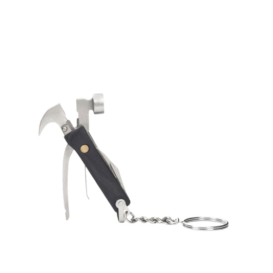 A compact multi-tool keychain with a black handle, silver metal tools including a small hammer, bottle opener, and wire wheel, attached to a split key ring on a plain white background.