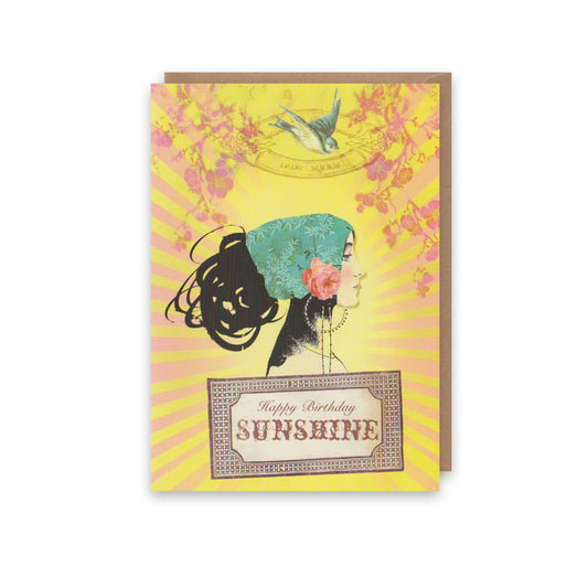 Greeting card with illustration of a woman's profile, floral elements, and 'Happy Birthday Sunshine' text on a yellow background