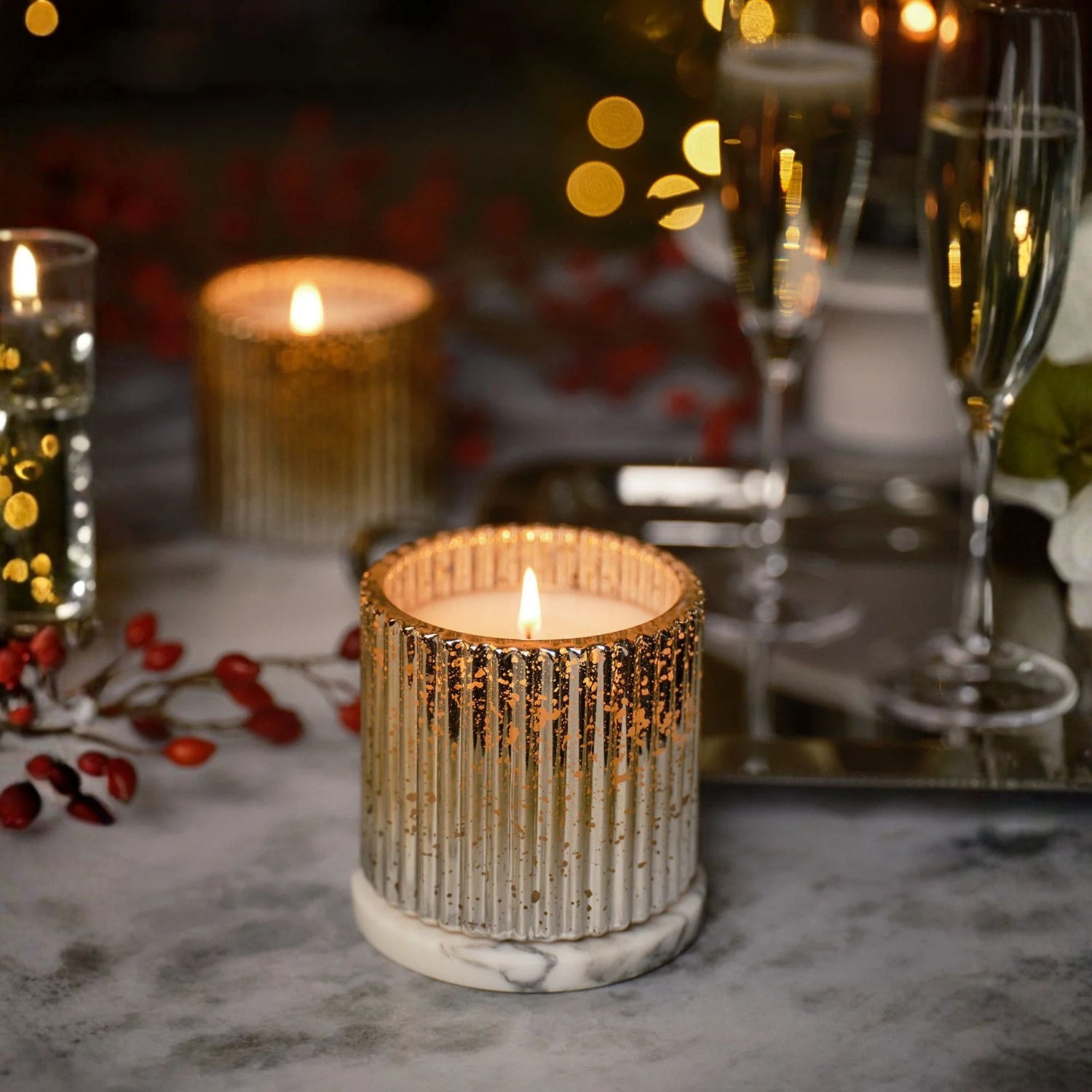 Candlelit table setting with glasses and decorative elements on a blurred background