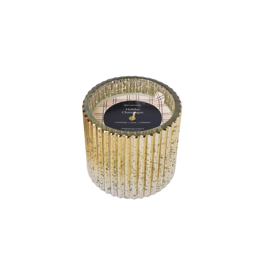 Decorative holiday champagne candle with gold ribbed design on a white background
