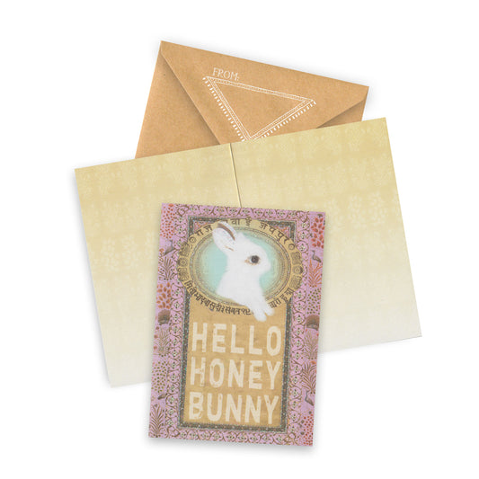 Greeting card with 'Hello Honey Bunny' text and a rabbit illustration, accompanied by a brown envelope on a white background