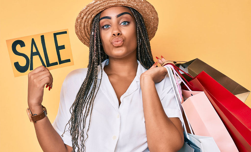 Woman with shopping bags and a 'SALE' sign on a yellow background