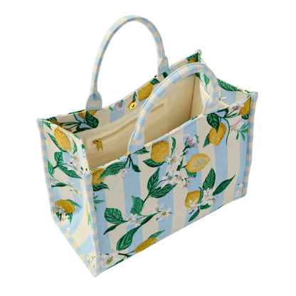 Open fabric tote bag with lemon and floral pattern on a white background