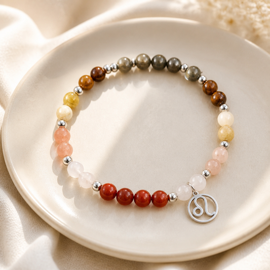 Beaded bracelet with a silver Leo charm on a beige plate