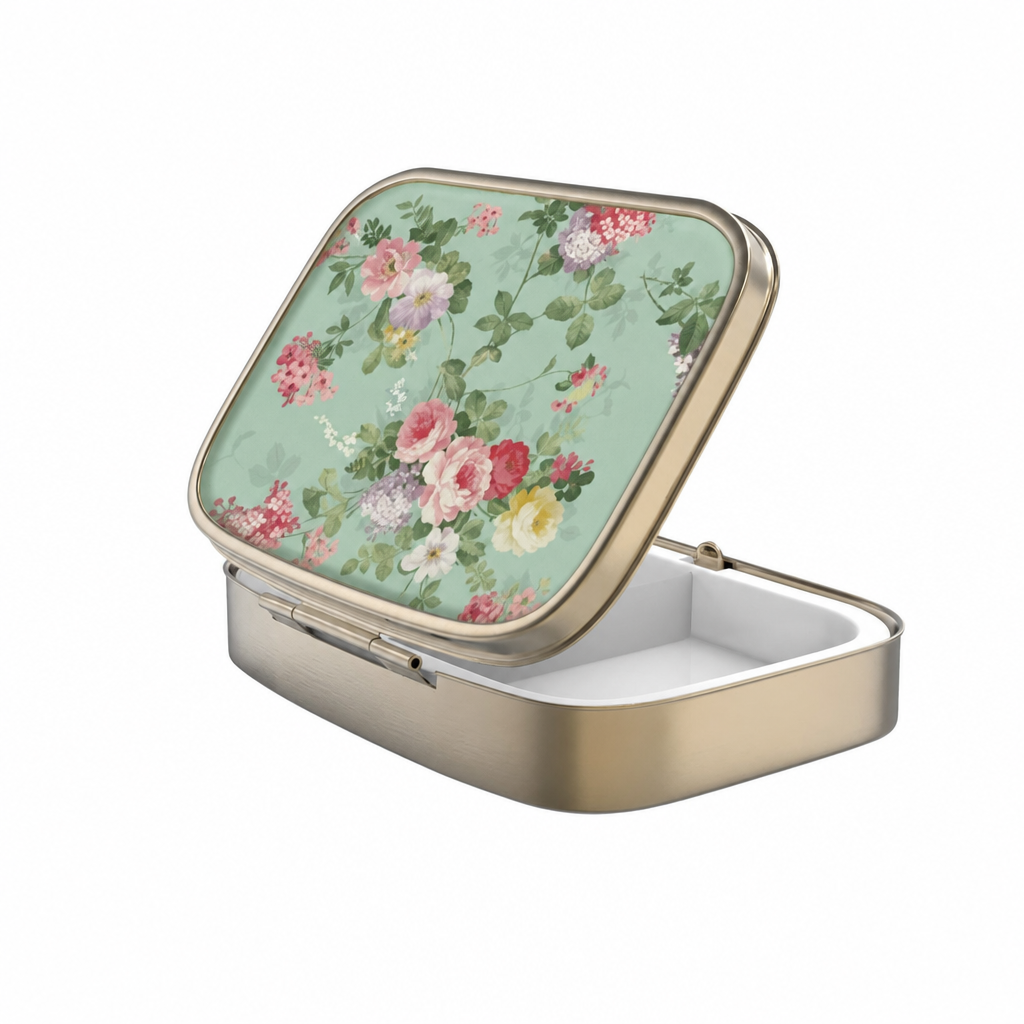 Portable rectangular pillbox featuring delicate botanical artwork and divided interior