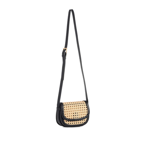 A small crossbody bag with a black leather body and a natural woven rattan front panel, featuring a long black shoulder strap and gold-tone hardware, shown against a plain white background.
