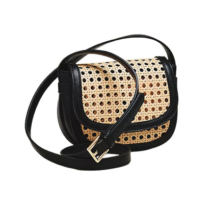 A black leather shoulder bag with a natural woven rattan front panel, featuring a gold-tone buckle detail on the strap and a black adjustable shoulder strap, shown against a plain white background.