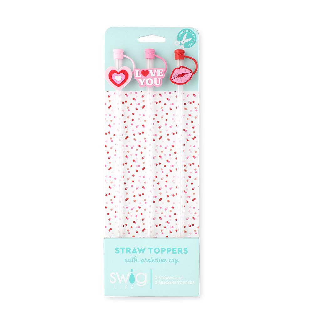Packaged straw toppers with heart and lips designs on a light blue background