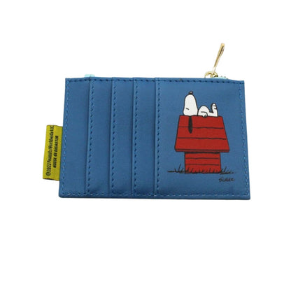 A blue faux-leather coin purse featuring a printed graphic of Snoopy and Woodstock on his red doghouse. The purse has a gold zipper pull and a yellow tag on the left side.