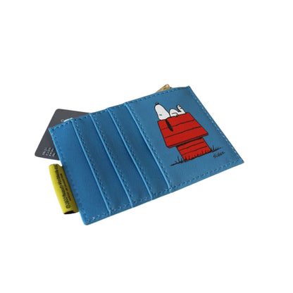 A blue faux leather cardholder wallet featuring a cartoon print of Snoopy in his red doghouse, with a yellow tag and a card partially visible.