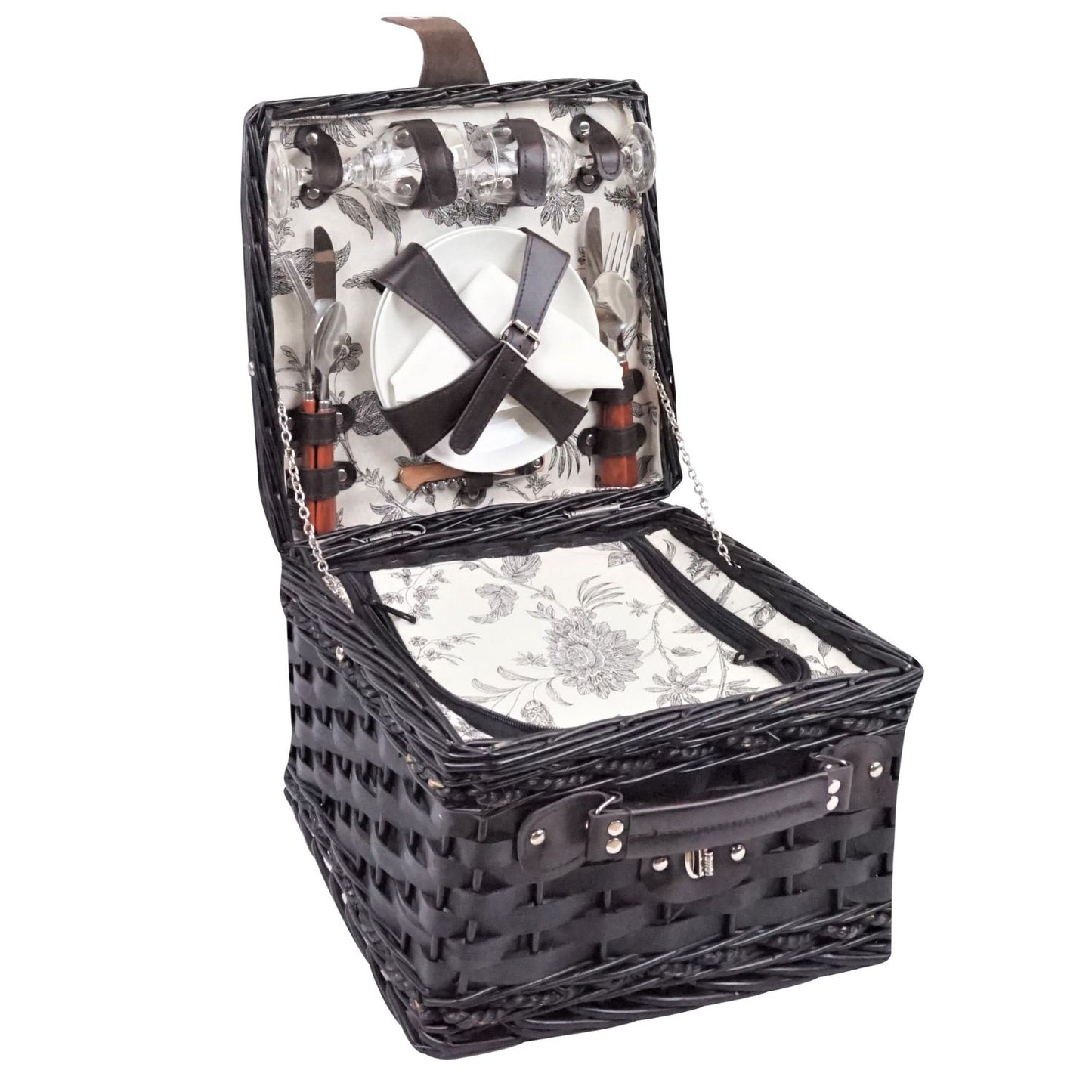 Open wicker picnic basket with cutlery and glass on a white background