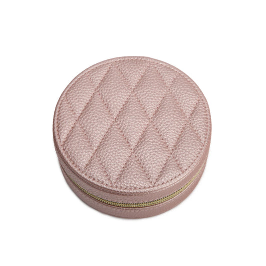 Round pink textured jewelry box with a gold zipper on a white background