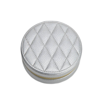 Round silver jewelry box with a textured surface on a white background