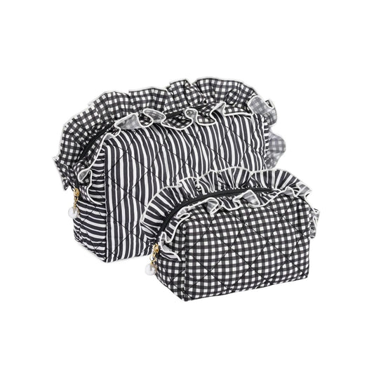 Two quilted cosmetic bags in black and white gingham and striped patterns with ruffled trim, displayed on a white background.