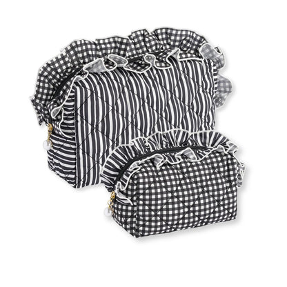 Large and a small  quilted bags in a black and white gingham and stripe pattern with ruffled trim, arranged on a white background.