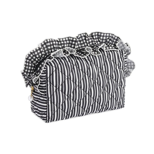 A quilted cosmetic bag with a black and white striped body, a black and white gingham ruffled trim, and a small gold zipper pull, shown on a plain white background.