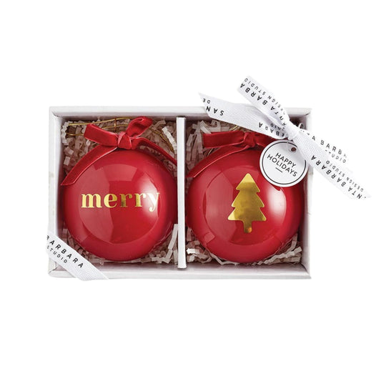 Set of two glossy red glass Christmas ornaments with gold Merry lettering and Christmas tree design, finished with red velvet bows.