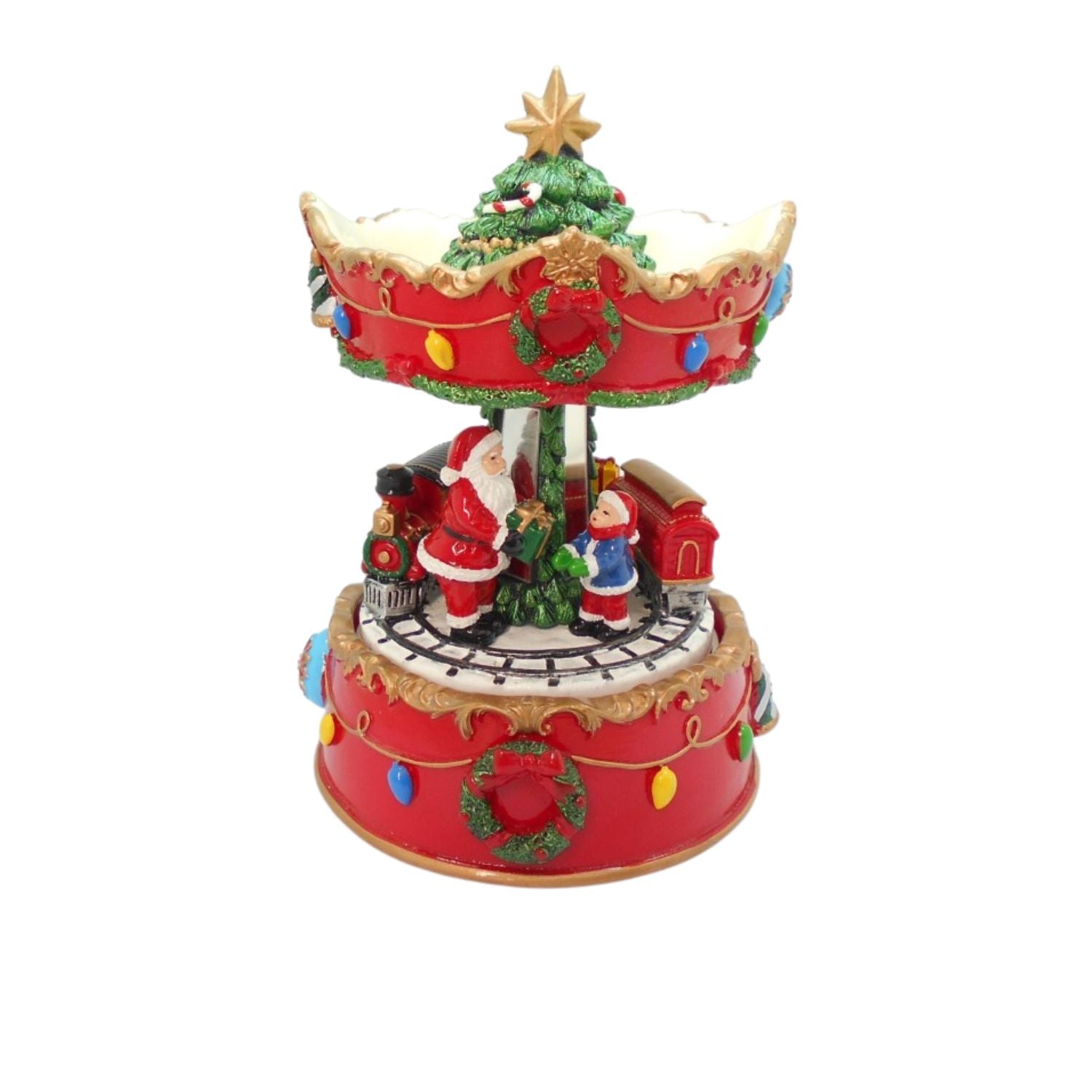 A festive Christmas carousel music box featuring Santa Claus, a decorated Christmas tree, snow, and colorful lights on a plain white background.