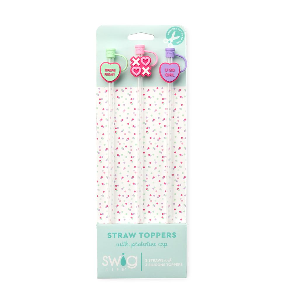 Packaged straw toppers with decorative caps on a white background