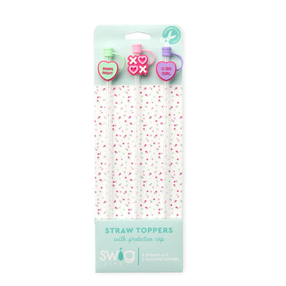 Packaged straw toppers with decorative caps on a white background